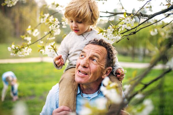 Grandson riding grandfather's shoulders | Alliant Private Client
