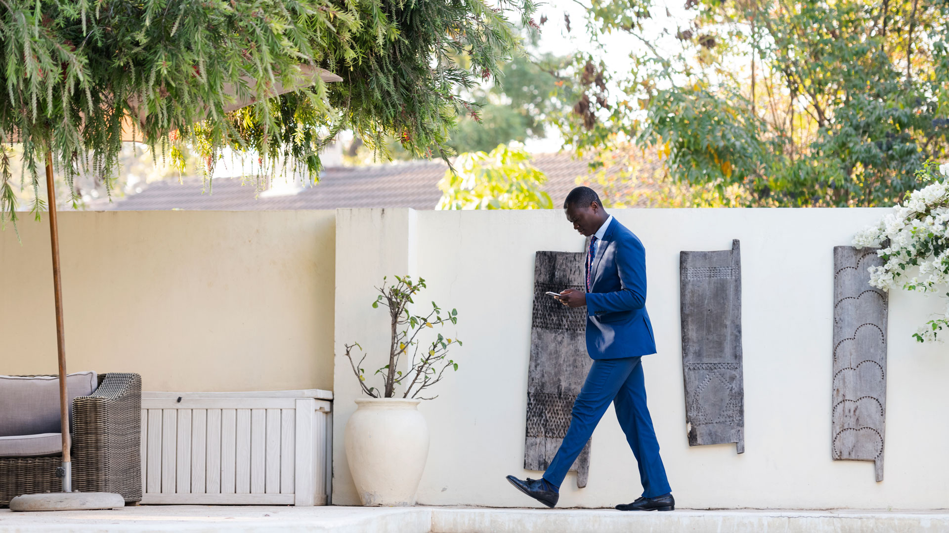 Distinguished man in a tailored suit on the phone, capturing the private, one-on-one attention and exclusive service offered by Alliant Private Client.
