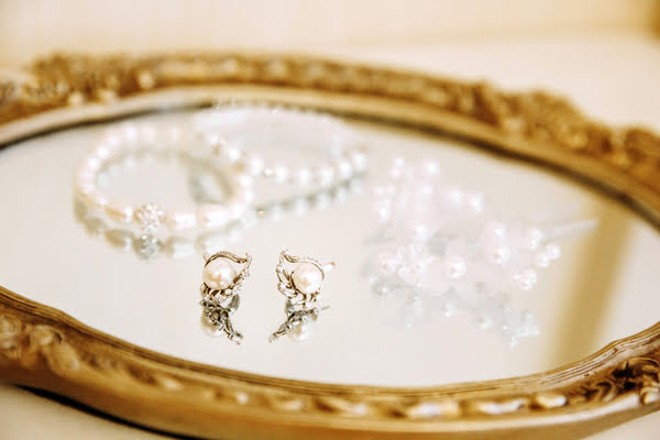 Pair of earrings on mirror | Alliant Private Client